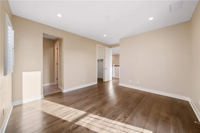 a view of a hallway with wooden floor and a fireplace