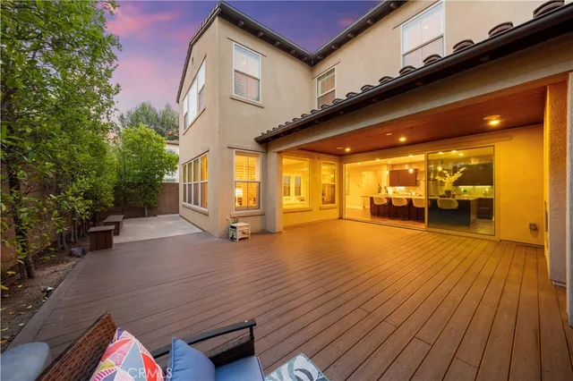 a view of a patio with table and chairs and wooden floor