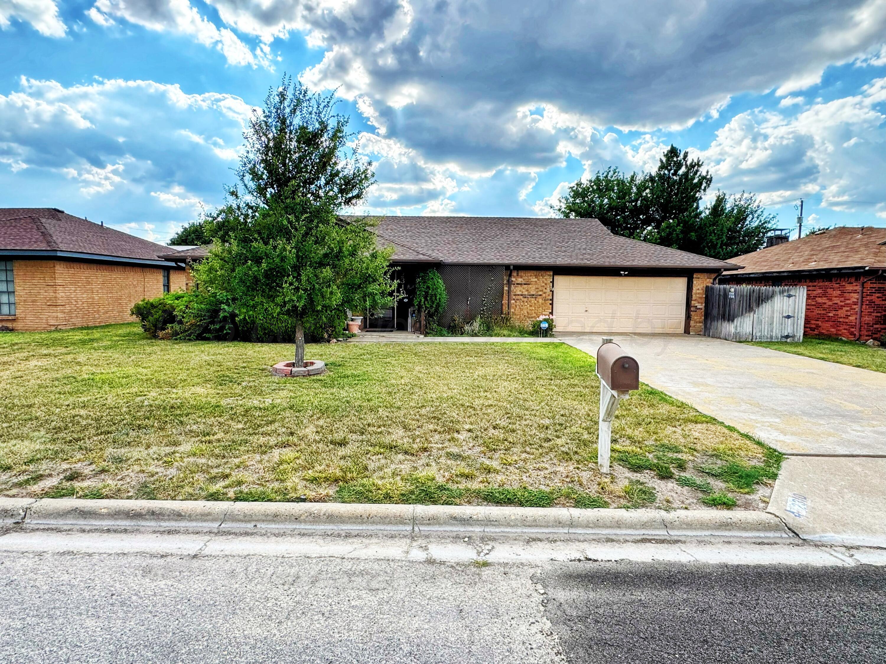 2310 South Elm Street Perryton, TX 79070 - Photo 1 of 24 a front view of a house with garden