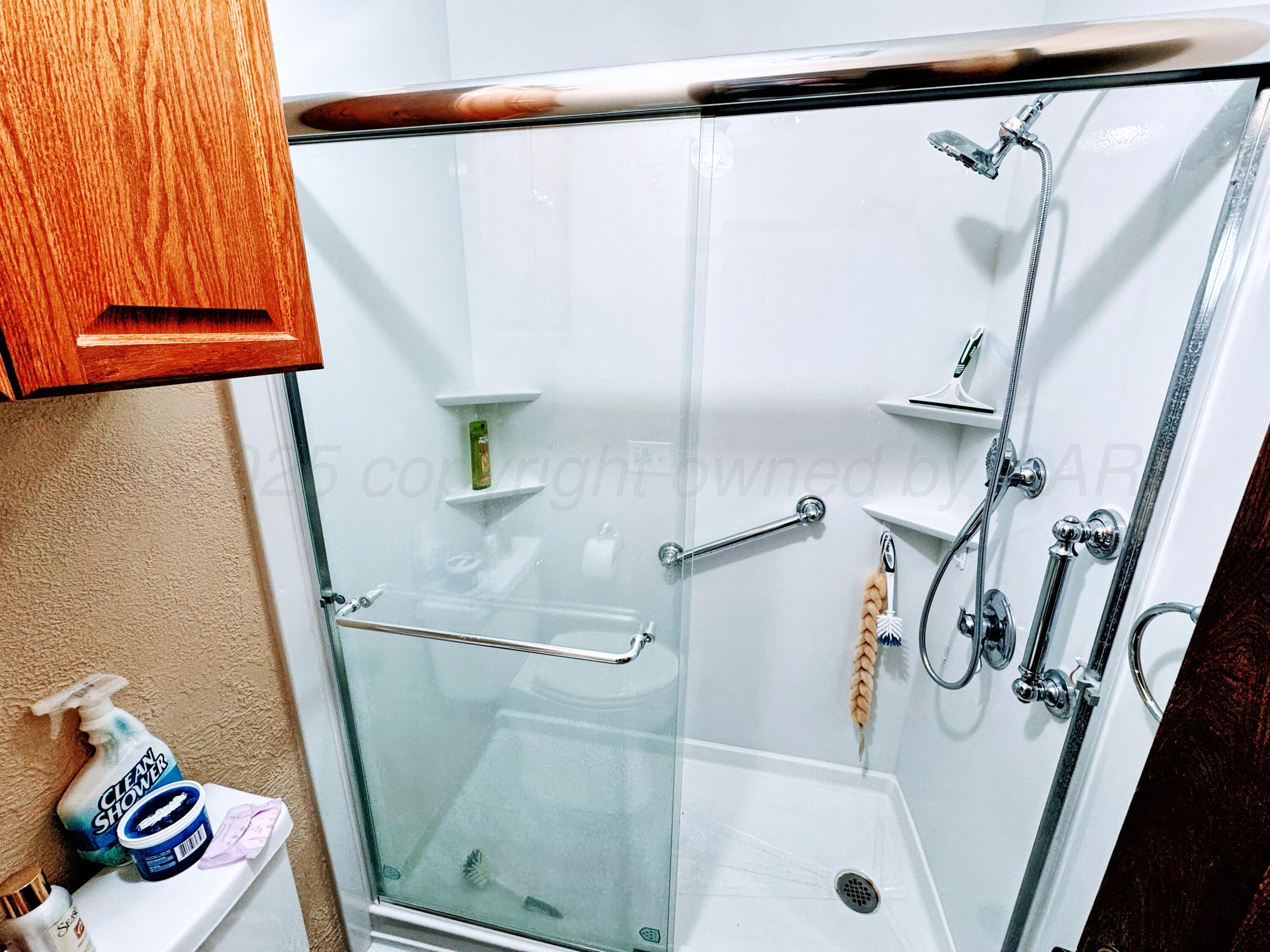2310 South Elm Street Perryton, TX 79070 - Photo 15 of 24 a bathroom with a sink and a shower