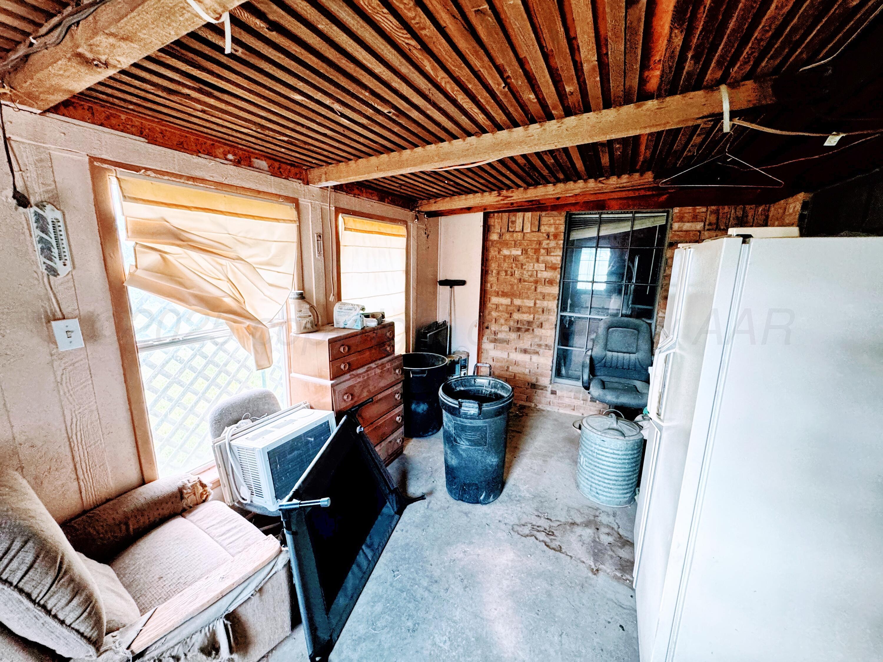 2310 South Elm Street Perryton, TX 79070 - Photo 18 of 24 a living room with furniture a wooden floor and a window