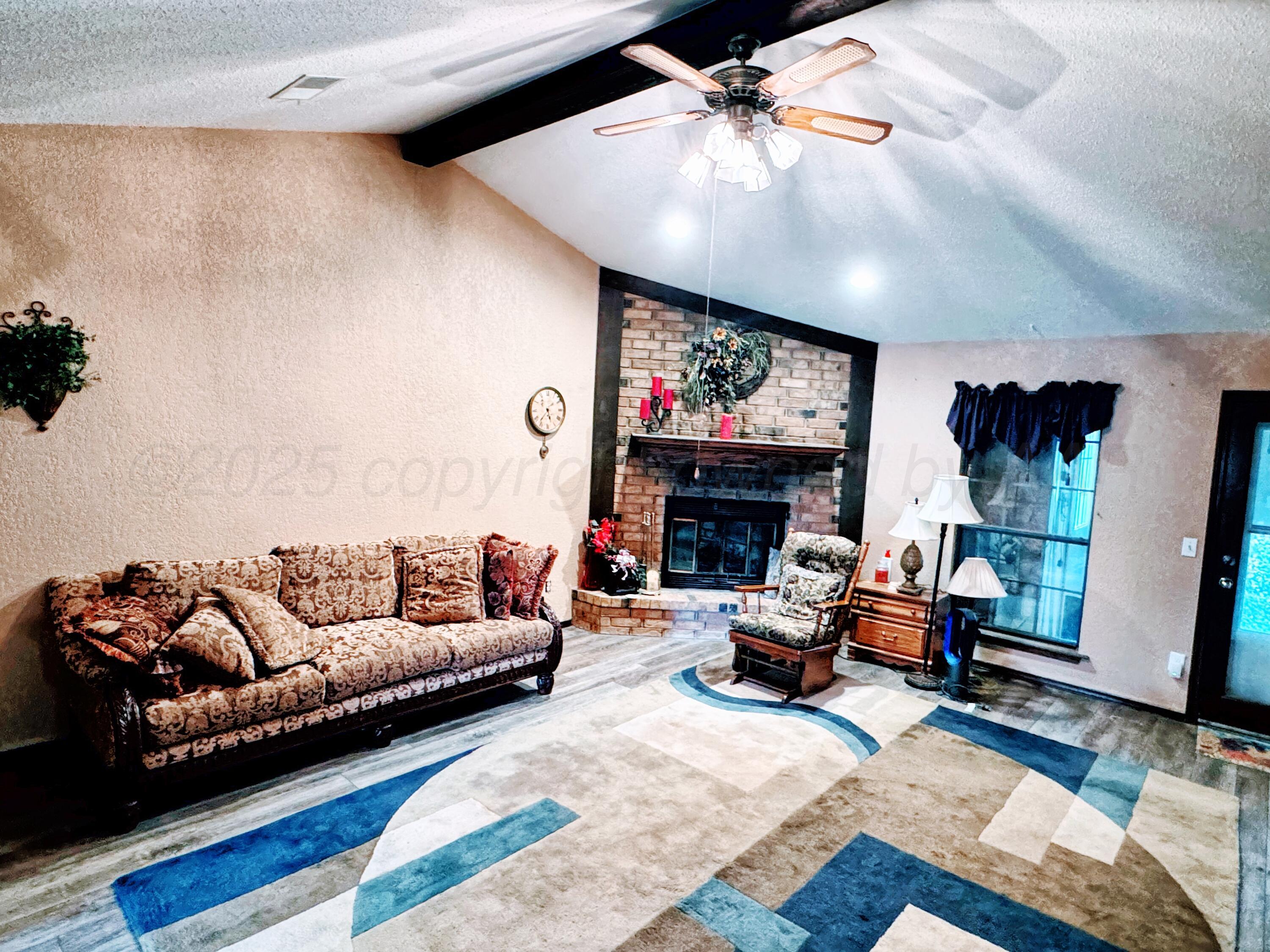 2310 South Elm Street Perryton, TX 79070 - Photo 3 of 24 a living room with furniture and a fireplace