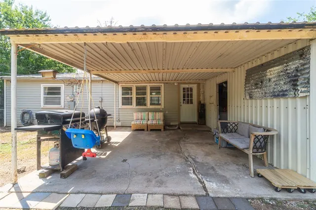 a view of a chair and table in the patio and a couple of lawn chairs