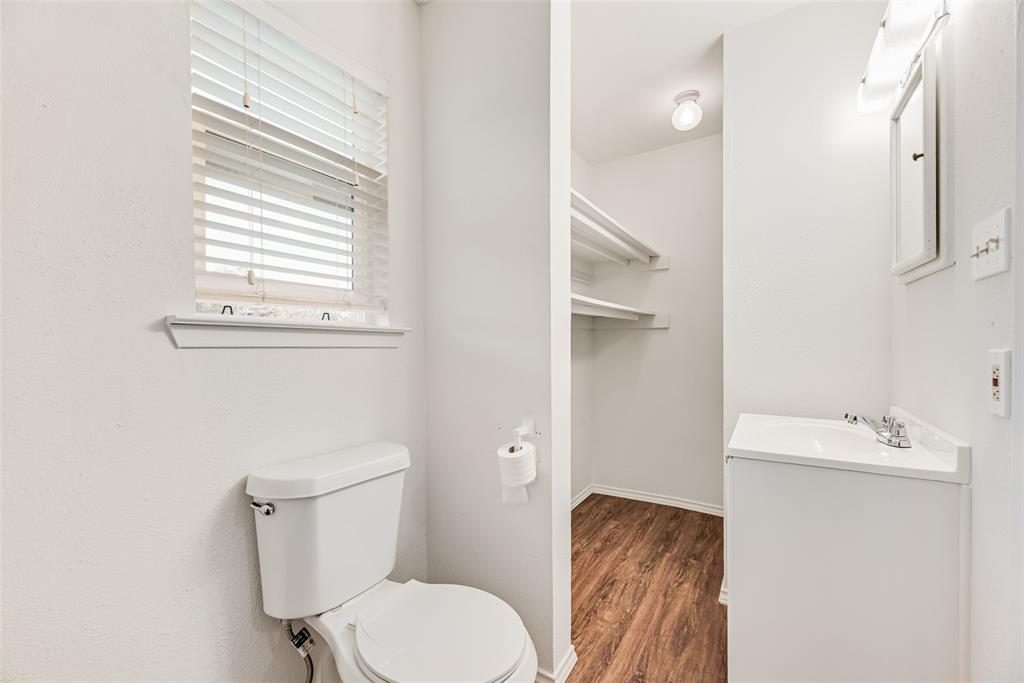 1017 Calcutta Street Hurst, TX 76053 - Photo 16 of 18 a white toilet sitting next to a bathroom sink