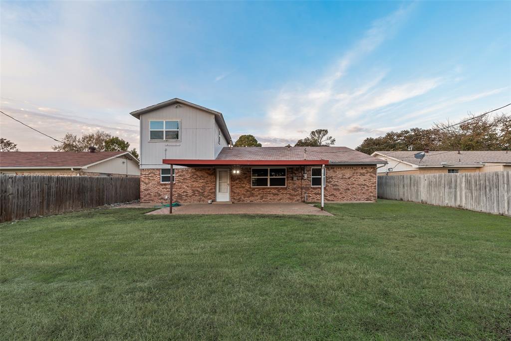 1017 Calcutta Street Hurst, TX 76053 - Photo 17 of 18 a front view of a house with a garden