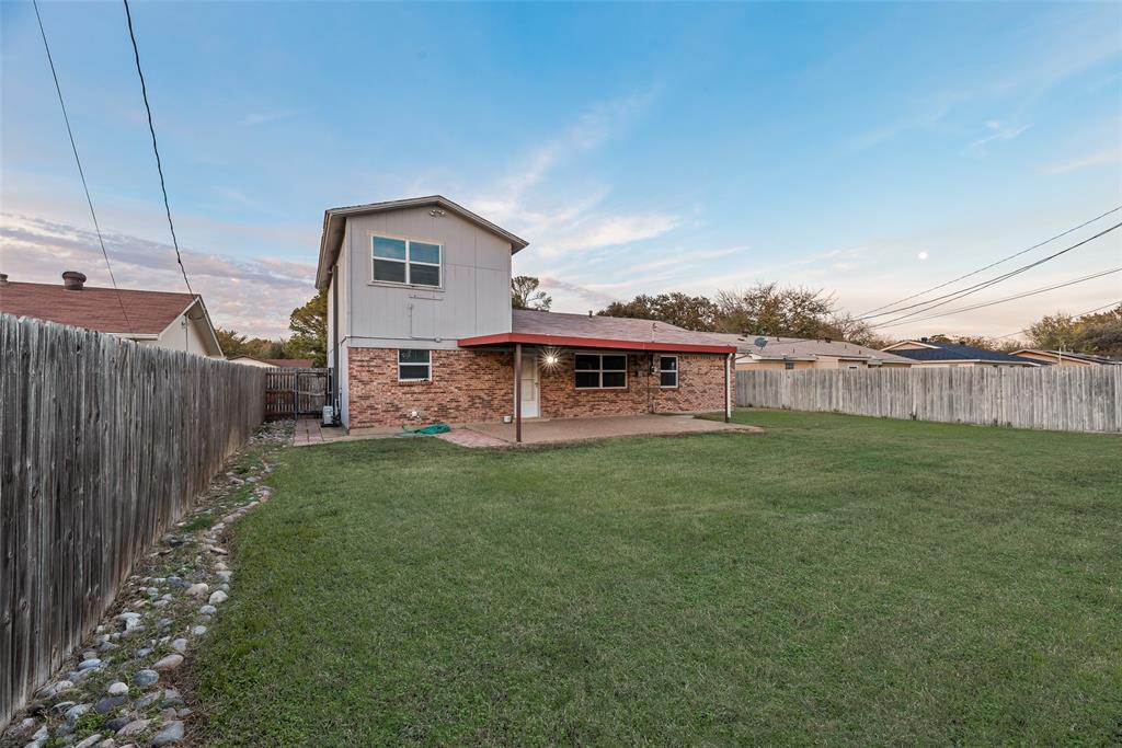 1017 Calcutta Street Hurst, TX 76053 - Photo 18 of 18 a view of a house with a yard and sitting area