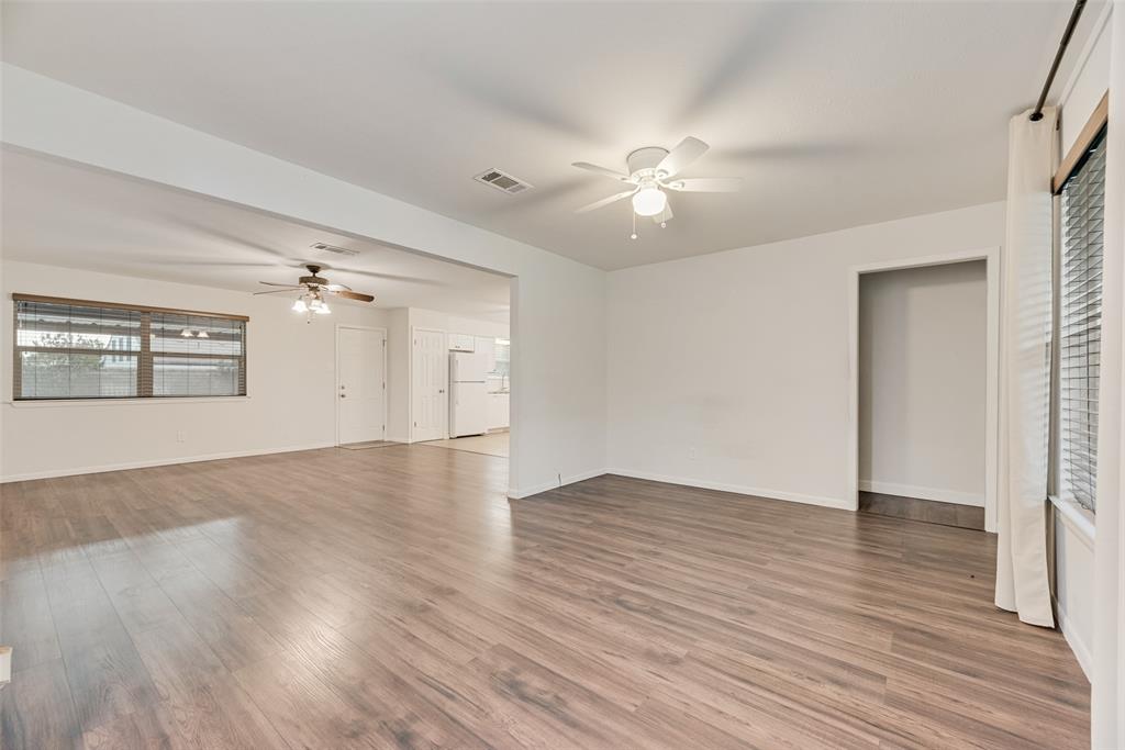 1017 Calcutta Street Hurst, TX 76053 - Photo 4 of 18 wooden floor in an empty room with a window