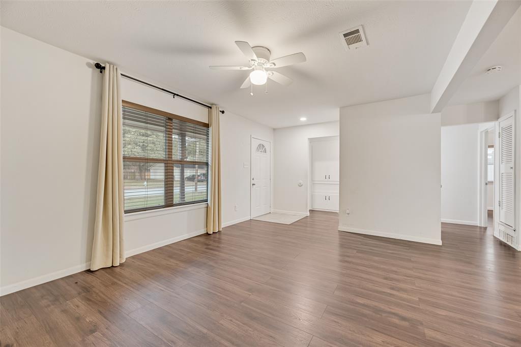 1017 Calcutta Street Hurst, TX 76053 - Photo 5 of 18 wooden floor in an empty room with a window