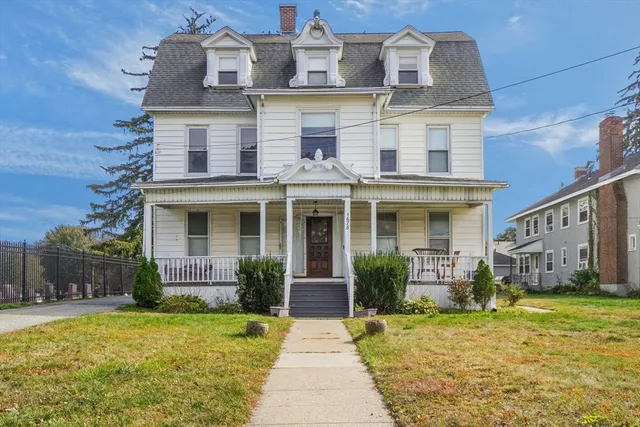 a front view of a house with garden