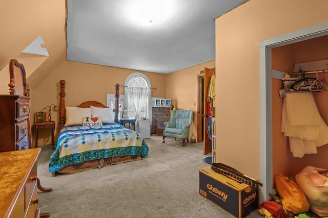 a living room with furniture a flat screen tv and a window
