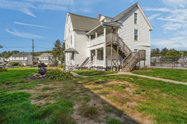 a view of a house with a yard and garage