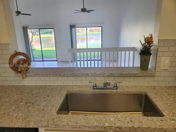 a kitchen with a sink a window and a counter top space