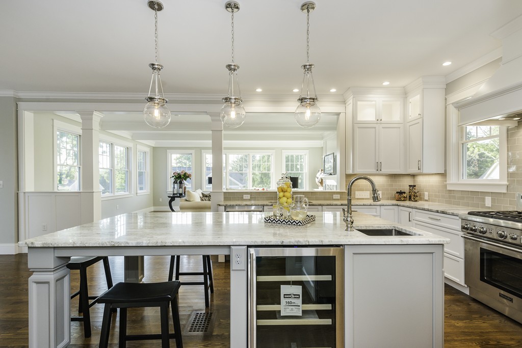19 Hinds Road Winchester, MA 01890 - Photo 7 of 29 a kitchen with kitchen island a dining table chairs and white cabinets