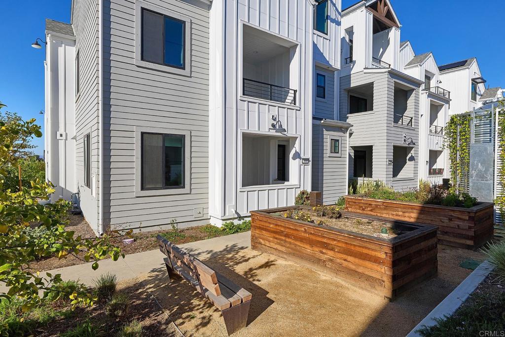 1601 San Remo Place, Unit 101 Encinitas, CA 92024 - Photo 16 of 27 a front view of a house with a yard