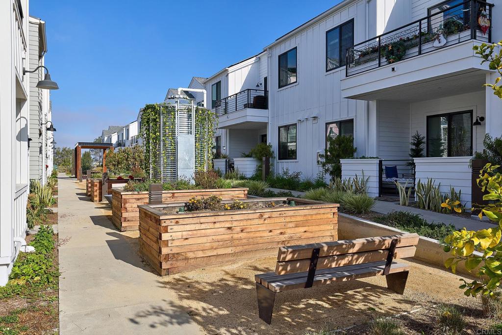 1601 San Remo Place, Unit 101 Encinitas, CA 92024 - Photo 17 of 27 a view of a building with garden and sitting area