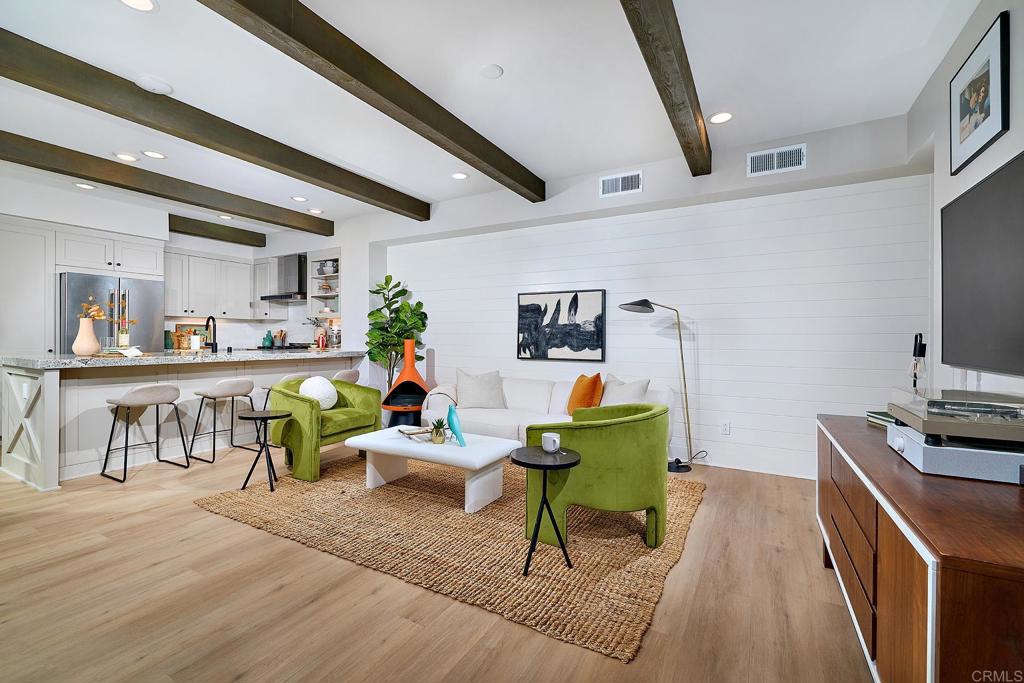 1601 San Remo Place, Unit 101 Encinitas, CA 92024 - Photo 2 of 27 a living room with furniture and a flat screen tv