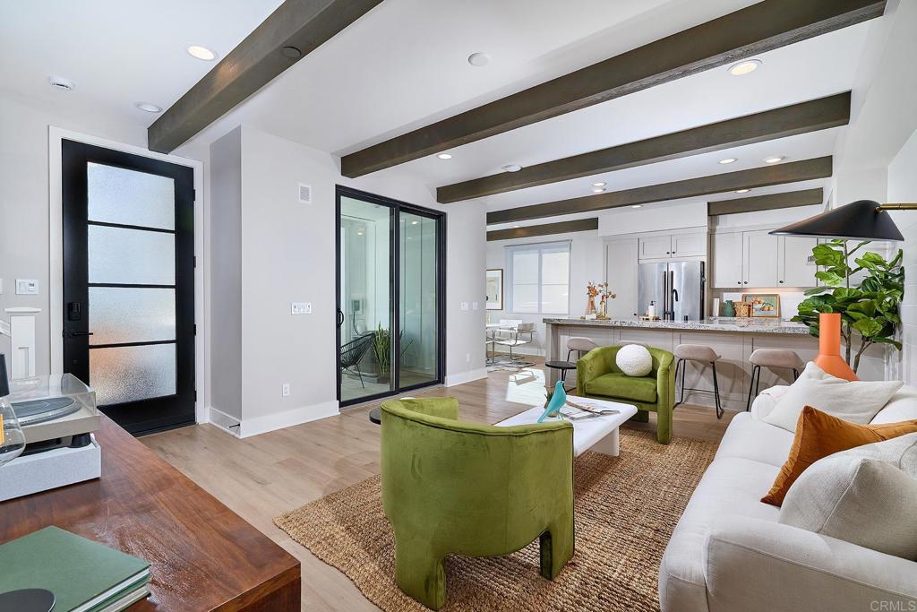 1601 San Remo Place, Unit 101 Encinitas, CA 92024 - Photo 3 of 27 a living room with furniture and a wooden floor
