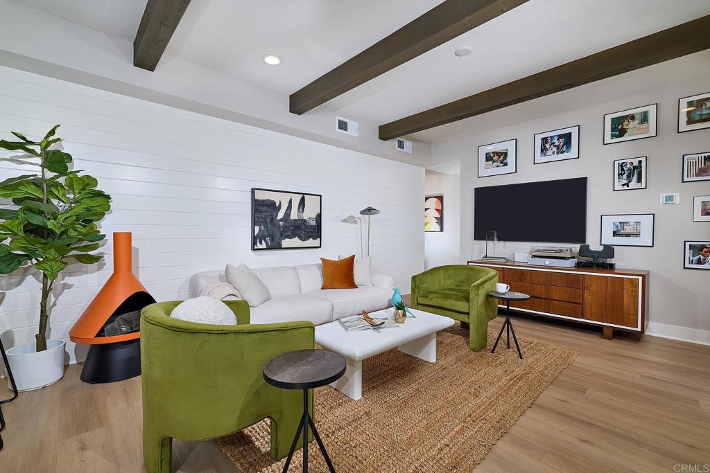 1601 San Remo Place, Unit 101 Encinitas, CA 92024 - Photo 4 of 27 a living room with furniture and a flat screen tv