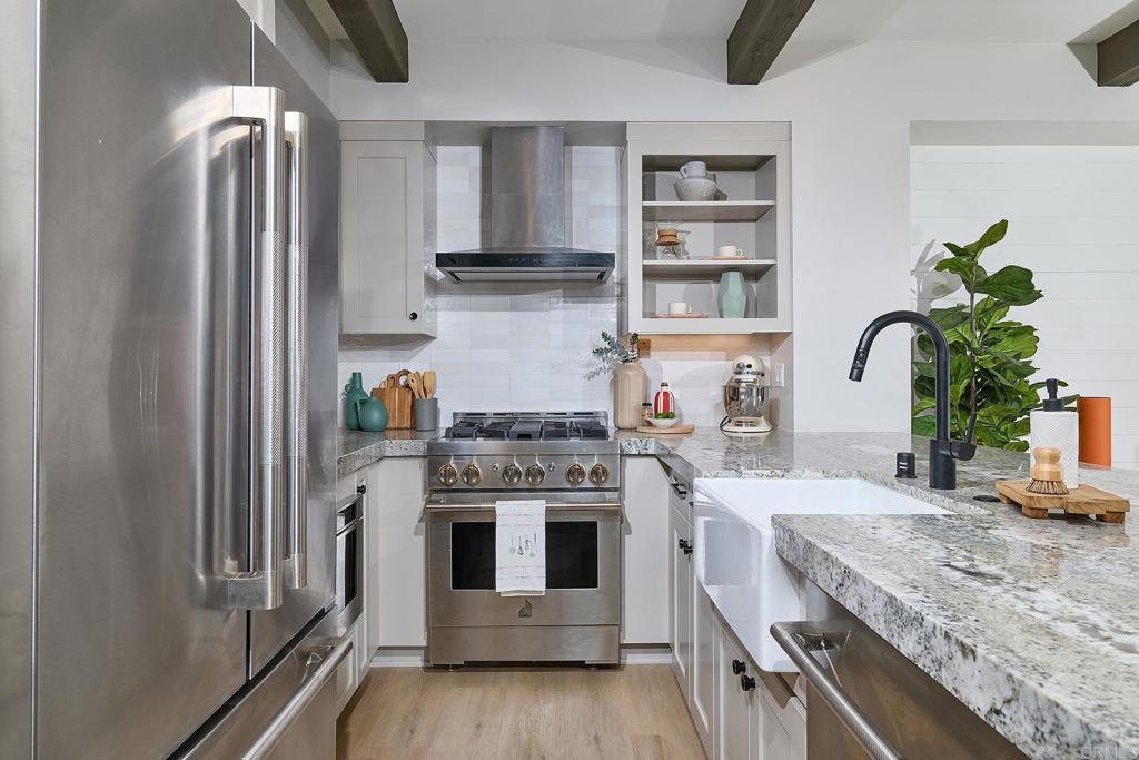 1601 San Remo Place, Unit 101 Encinitas, CA 92024 - Photo 6 of 27 a kitchen with stainless steel appliances granite countertop a stove a sink and a refrigerator