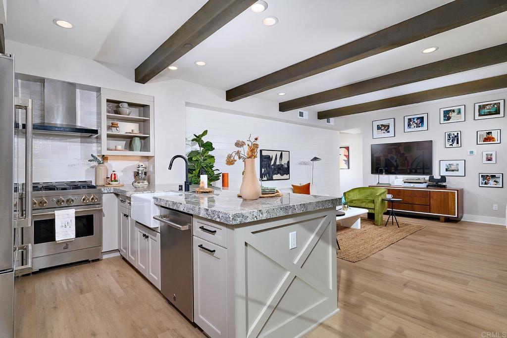 1601 San Remo Place, Unit 101 Encinitas, CA 92024 - Photo 8 of 27 a kitchen with stainless steel appliances granite countertop a stove and cabinets