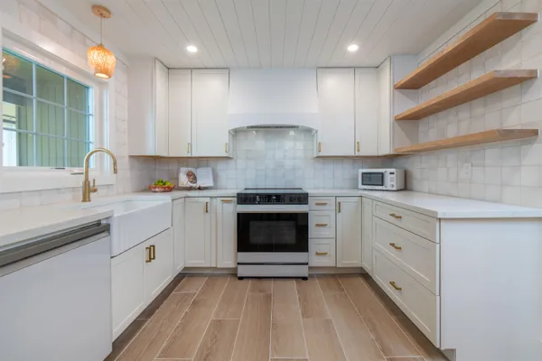 a kitchen with cabinets appliances and a sink