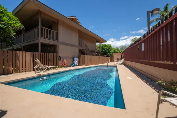 a view of a backyard with a slide and wooden fence
