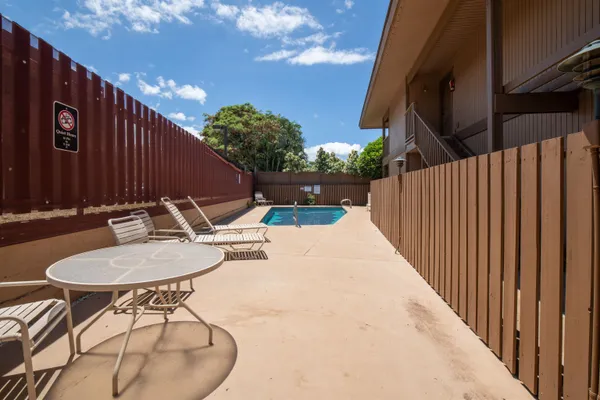 a backyard of a house with table and chairs