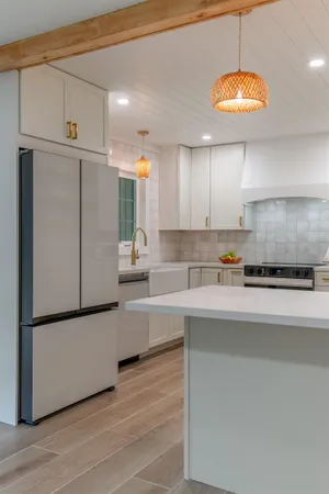 a kitchen with kitchen island a counter top space cabinets and stainless steel appliances