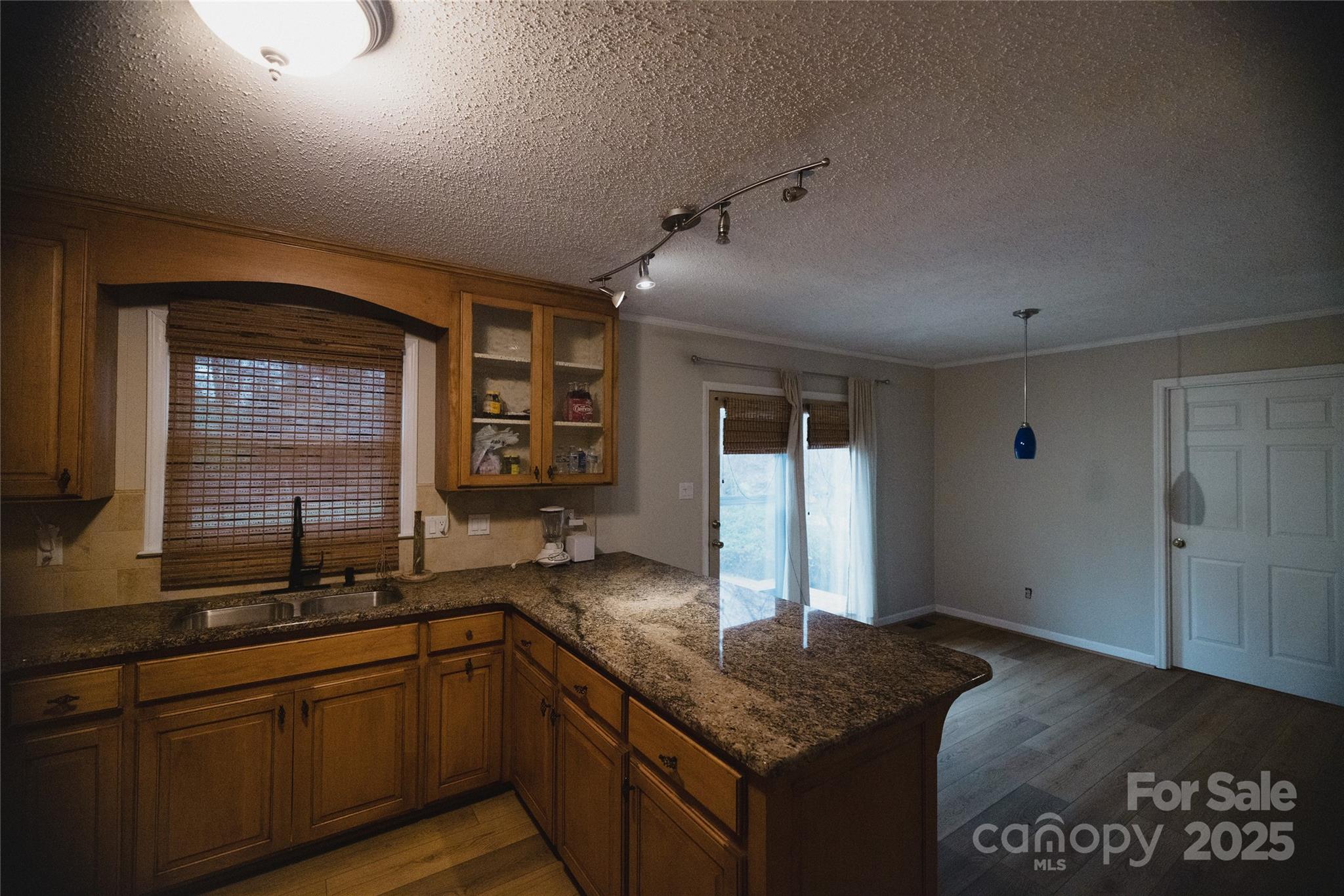451 James Farm Road Statesville, NC 28625 - Photo 14 of 30 a kitchen with granite countertop sink and cabinets
