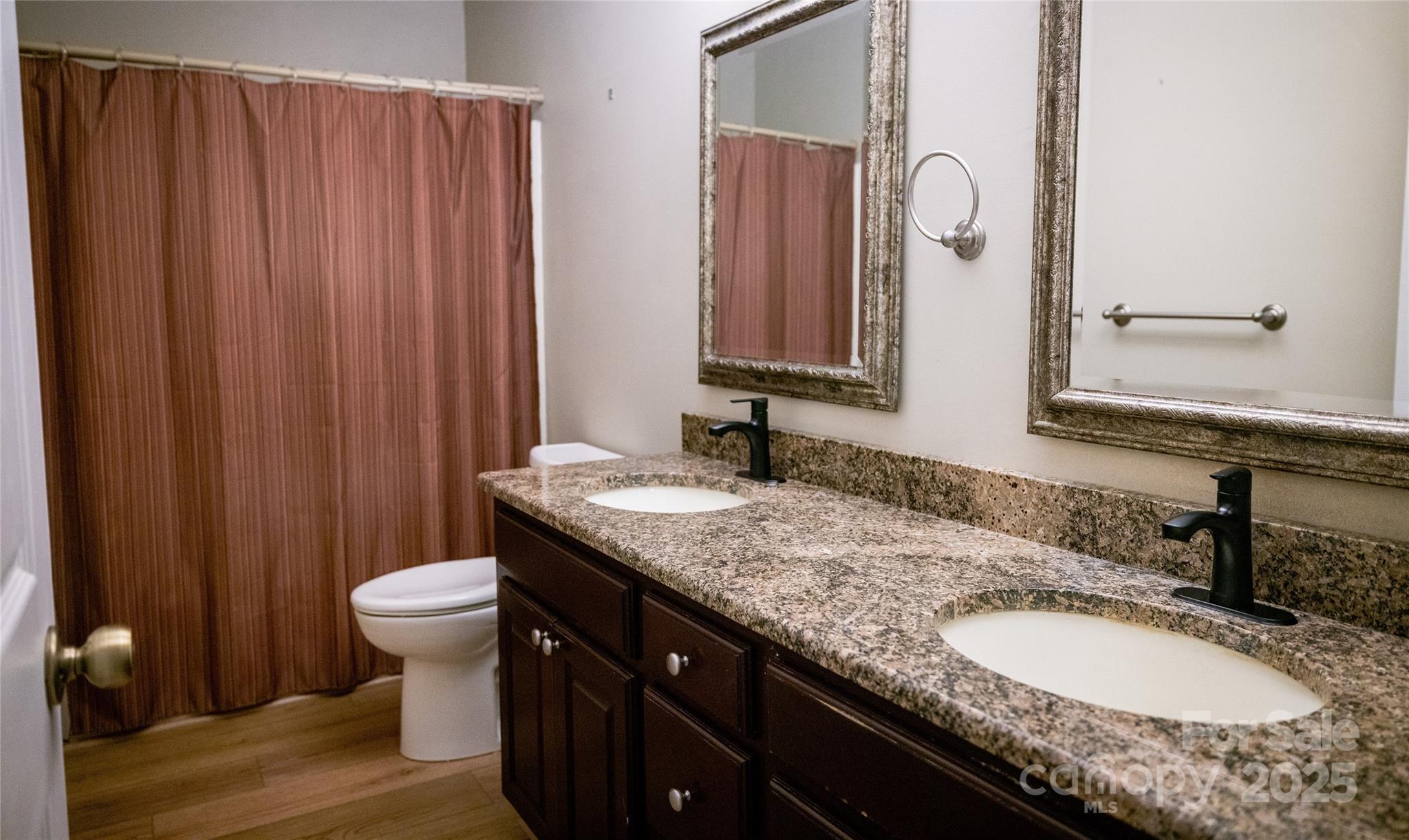 451 James Farm Road Statesville, NC 28625 - Photo 16 of 30 a bathroom with a granite countertop sink and a mirror