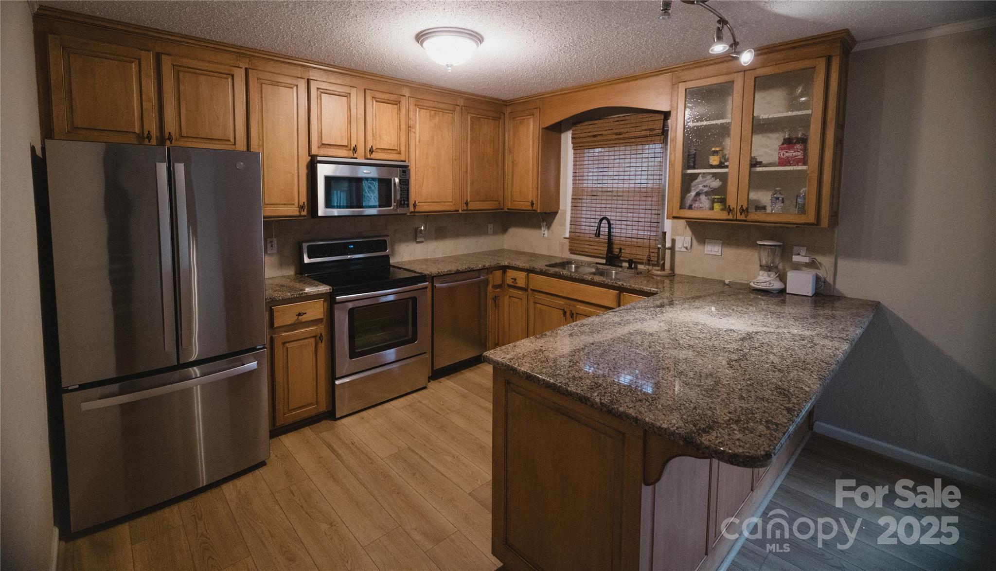 451 James Farm Road Statesville, NC 28625 - Photo 23 of 30 a kitchen with granite countertop stainless steel appliances and wooden cabinets