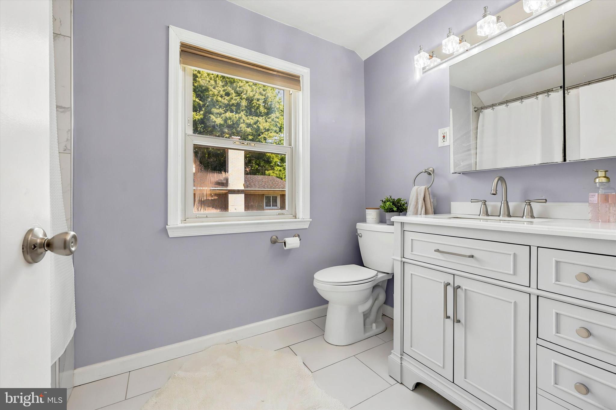 39 Haverford Road Ardmore, PA 19003 - Photo 22 of 24 a bathroom with a toilet sink vanity and window