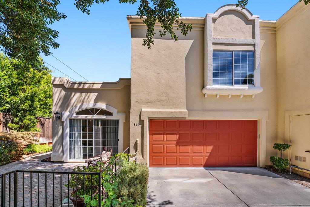 a front view of a house with plants
