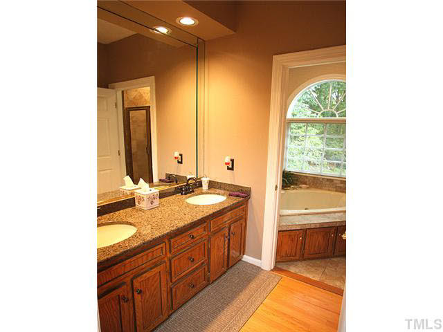 4020 Ridgebrook Bluffs Drive Raleigh, NC 27603 - Photo 8 of 14 New granite, ceramic tile, & fixtures have been added to all bathrooms. Whirlpool tub & separate shower make for a wonderful downstairs retreat. Master Bath/Spa
