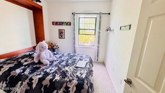 1414 Vista Cove Road St. Augustine, FL 32084 - Photo 24 of 29 a bedroom with a bed and a window