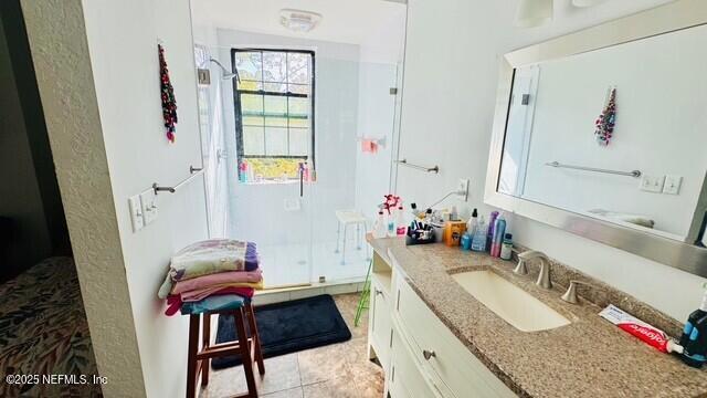 1414 Vista Cove Road St. Augustine, FL 32084 - Photo 26 of 29 a bathroom with a granite countertop sink a toilet and shower