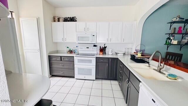 1414 Vista Cove Road St. Augustine, FL 32084 - Photo 5 of 29 a kitchen with a sink a stove and cabinets