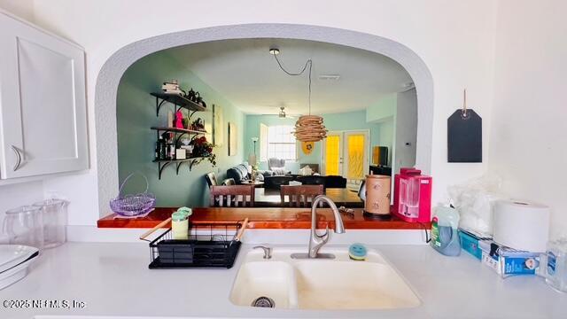 1414 Vista Cove Road St. Augustine, FL 32084 - Photo 9 of 29 a living room with furniture and a chandelier