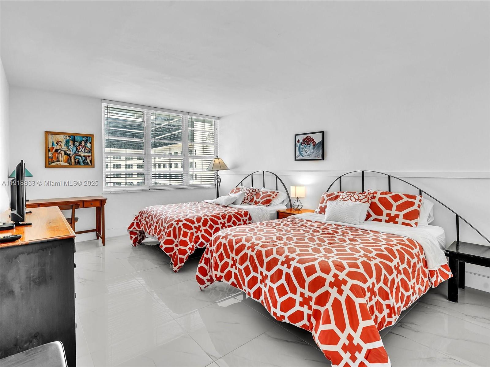 100 Lincoln Road, Unit 710 Miami Beach, FL 33139 - Photo 16 of 36 a bedroom with two beds and a couch