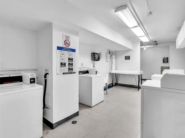 a view of kitchen and white cabinets