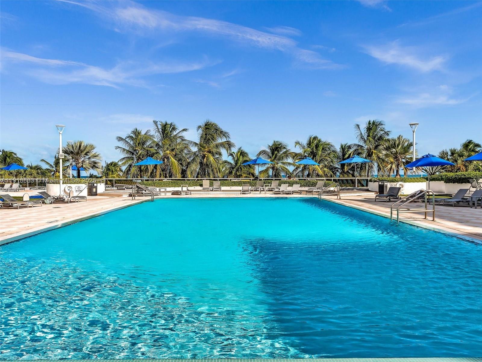 100 Lincoln Road, Unit 710 Miami Beach, FL 33139 - Photo 23 of 36 a view of a swimming pool with an outdoor space and seating area
