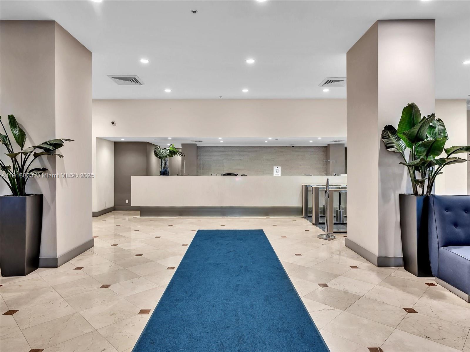 100 Lincoln Road, Unit 710 Miami Beach, FL 33139 - Photo 30 of 36 a large white room with bed and a potted plant