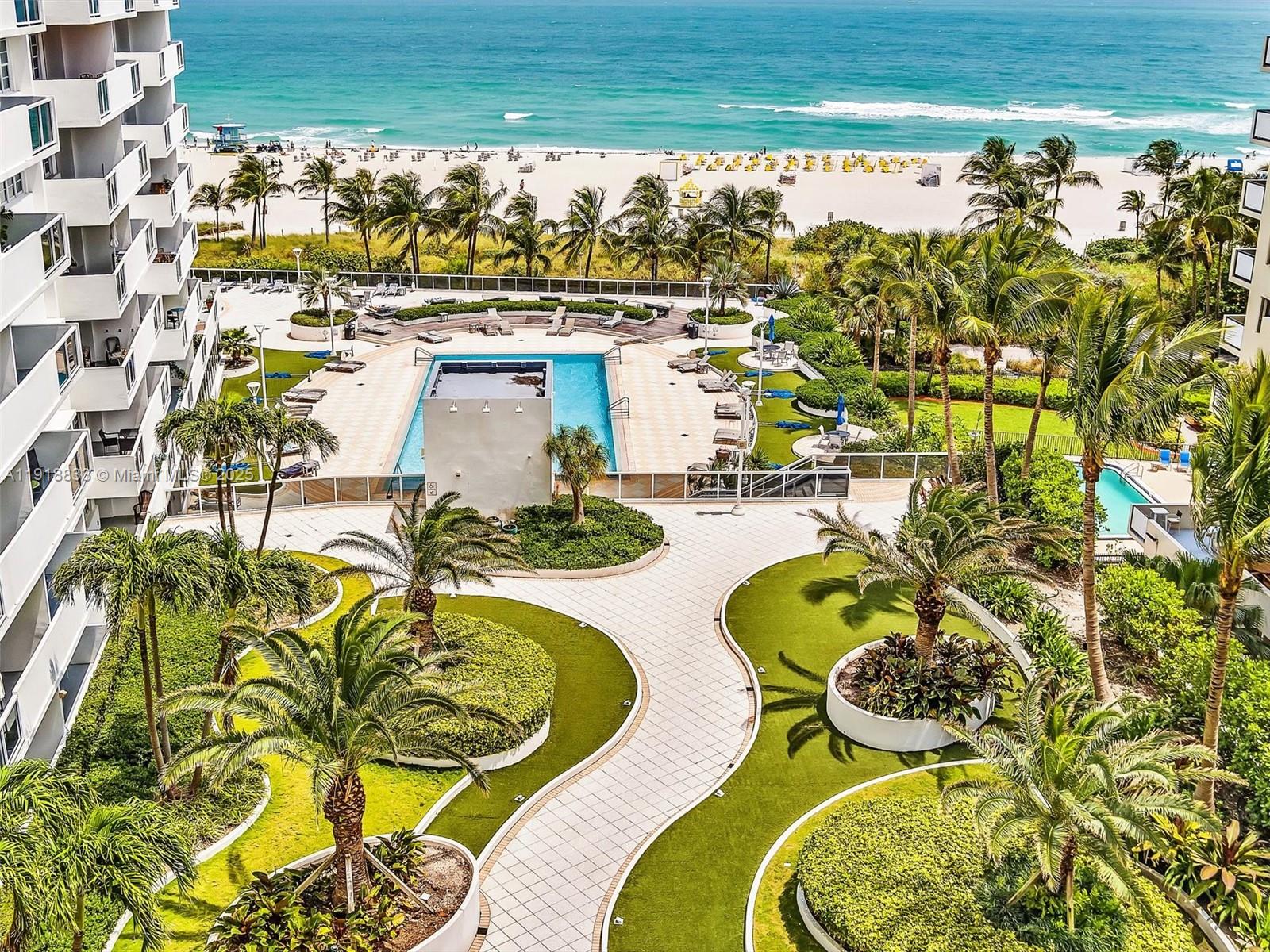 100 Lincoln Road, Unit 710 Miami Beach, FL 33139 - Photo 34 of 36 a view of a swimming pool with a dining table and chairs
