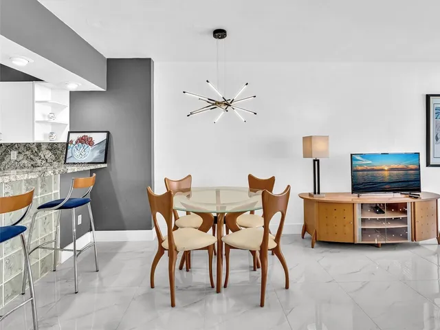 a view of a livingroom with furniture and flat screen tv