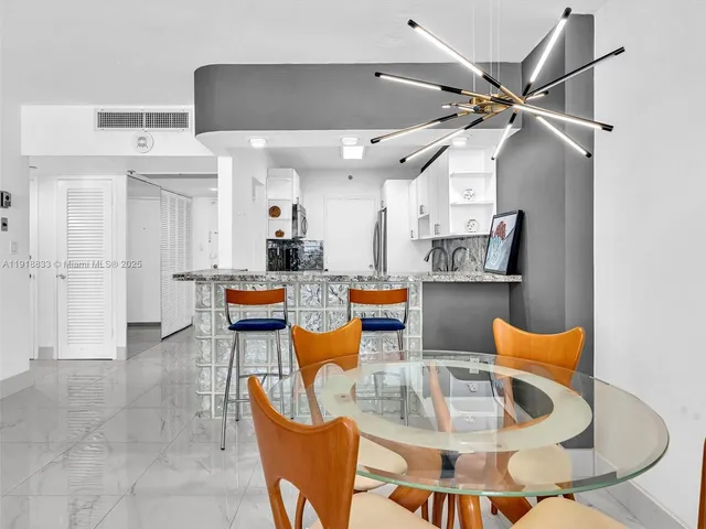 a living room with lots of furniture and kitchen view