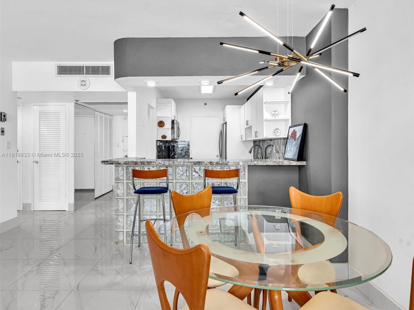 100 Lincoln Road, Unit 710 Miami Beach, FL 33139 - Photo 8 of 36 a living room with lots of furniture and kitchen view