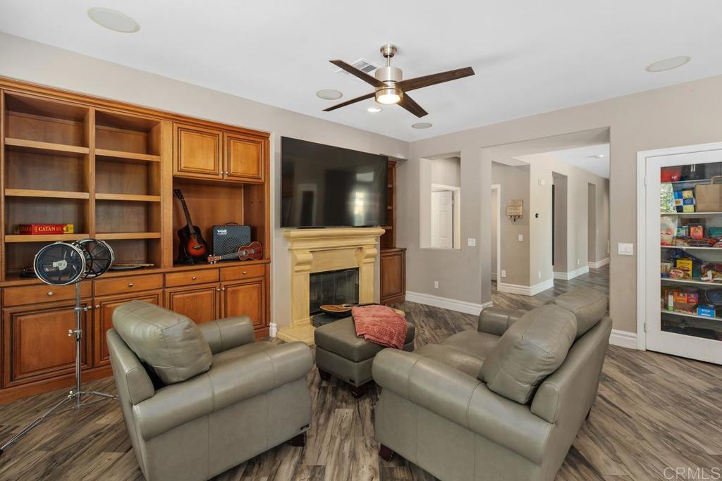 44684 Mumm Street Temecula, CA 92592 - Photo 11 of 51 a living room with furniture a fireplace and a flat screen tv