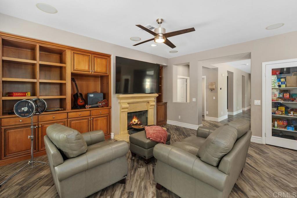 44684 Mumm Street Temecula, CA 92592 - Photo 12 of 51 a living room with furniture a fireplace and a flat screen tv