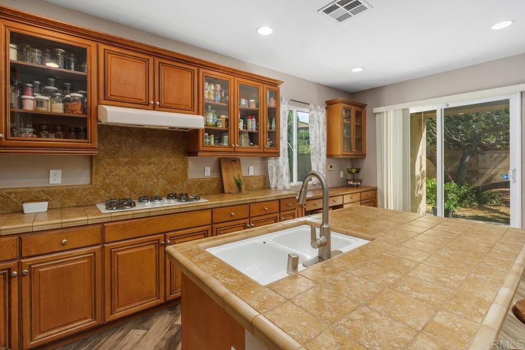44684 Mumm Street Temecula, CA 92592 - Photo 17 of 51 a kitchen with stainless steel appliances granite countertop a sink and cabinets