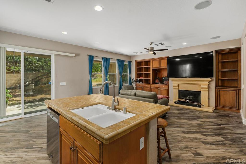 44684 Mumm Street Temecula, CA 92592 - Photo 18 of 51 a kitchen with a sink a fireplace and chairs in it